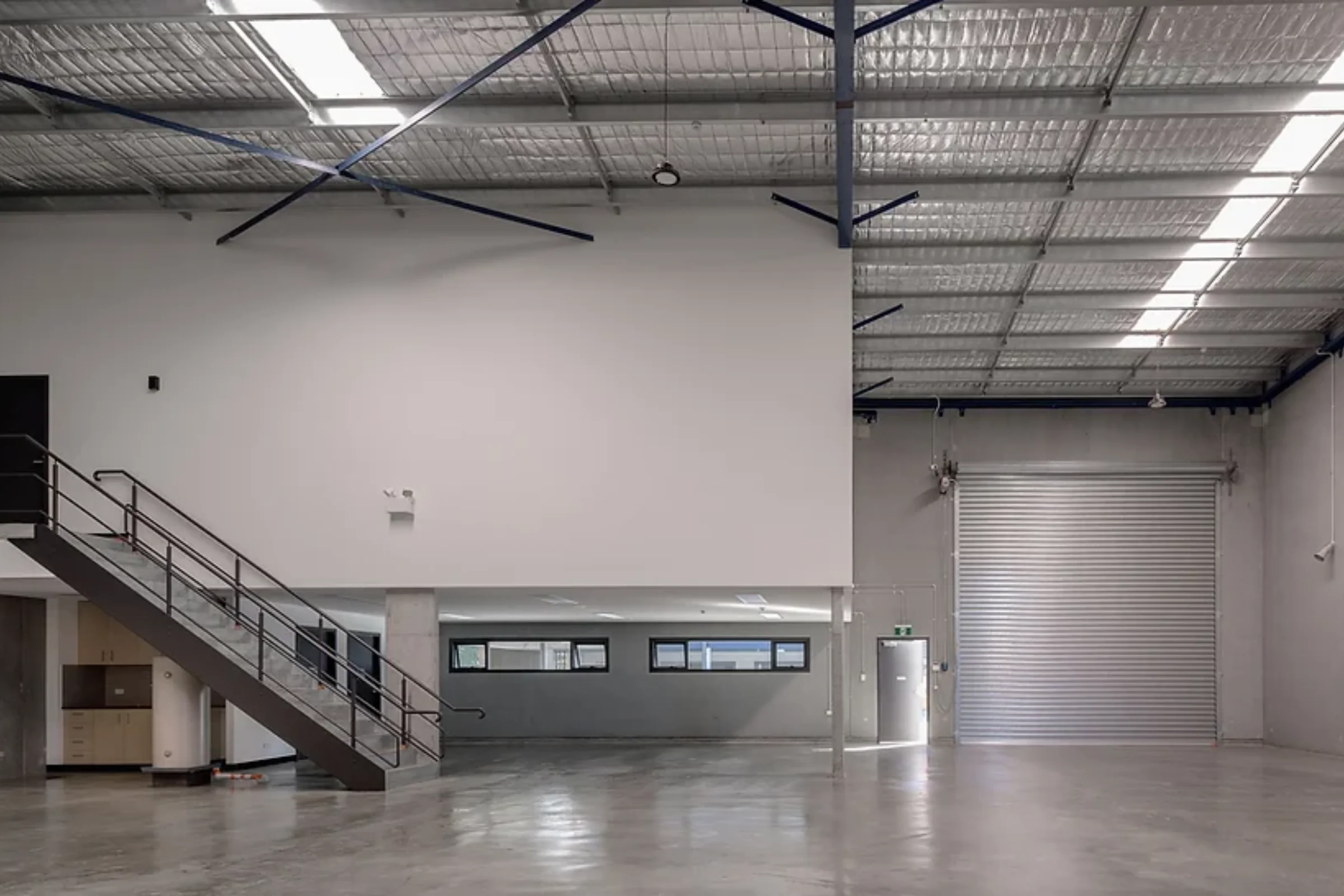 Interior of a business unit at The Borough, Matraville, with mezzanine and roller door